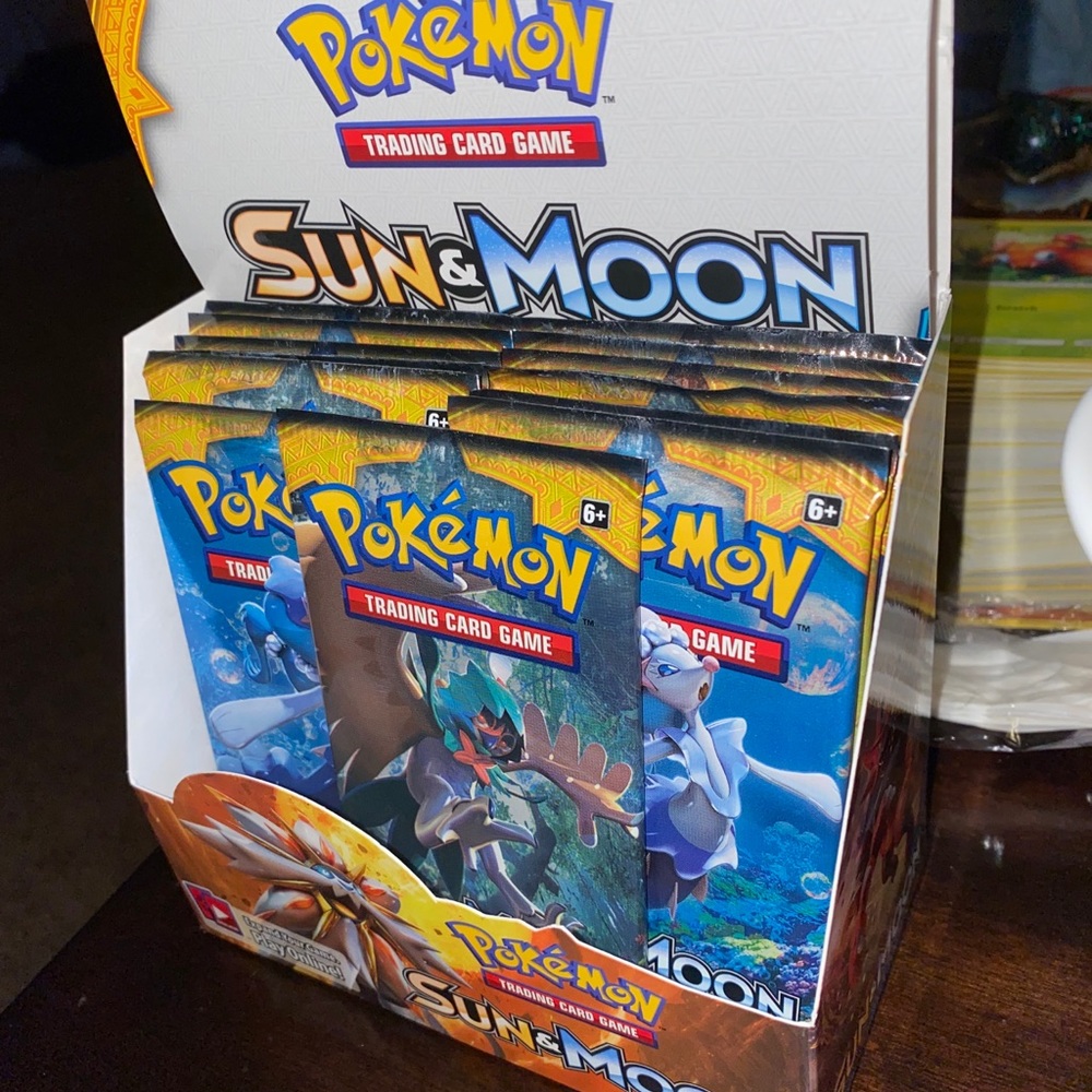 14 unopened packs of Sun and Moon Booster Pack